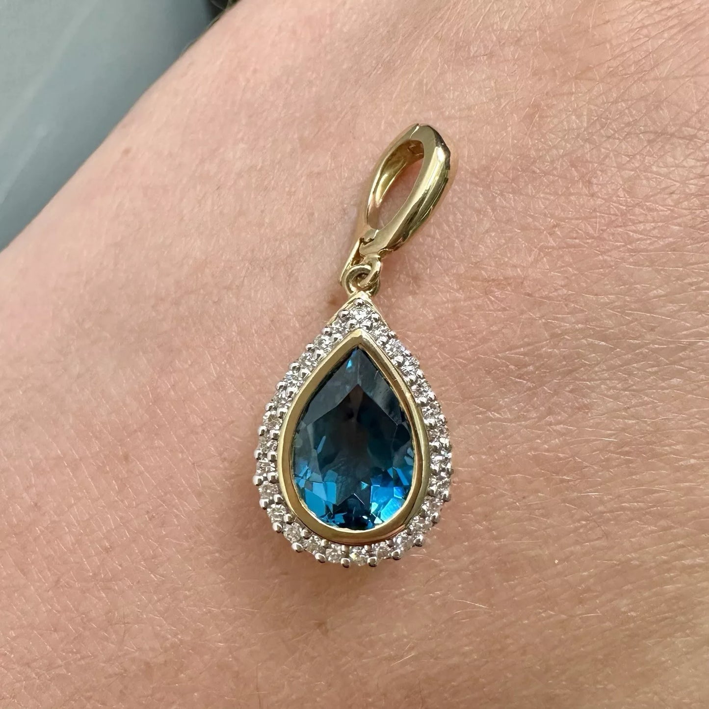 9Ct Yellow Gold London Blue Topaz & .20 Carat TW Diamond Enhancer Pendant