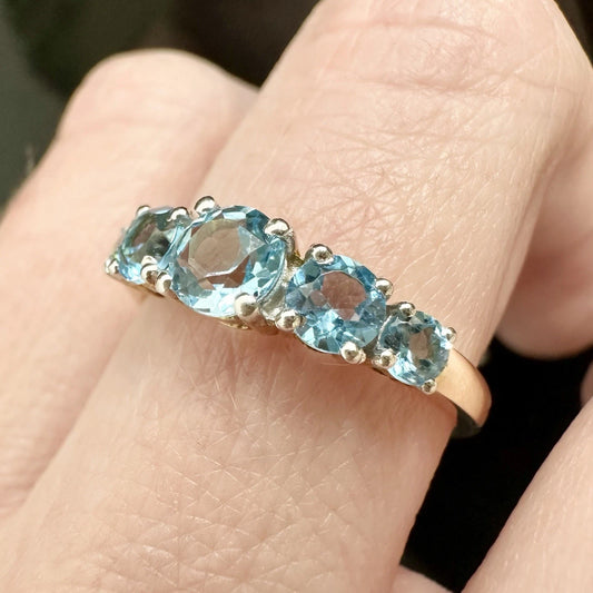 9Ct Yellow Gold Graduating Blue Topaz Ring Sz O 1/2
